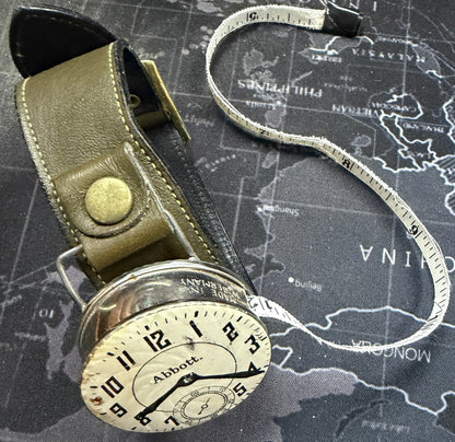 Vintage-style measuring tape on a world map background