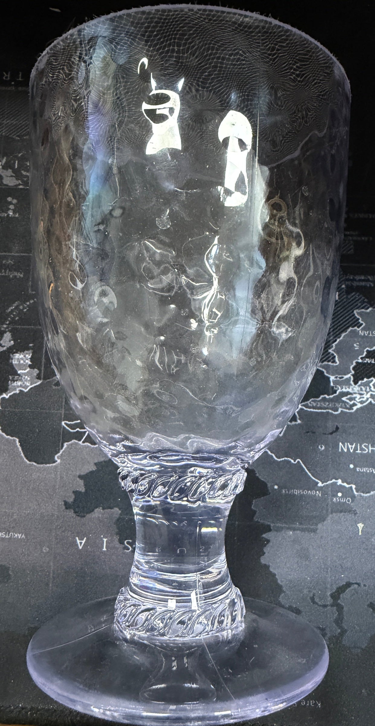 Decorative glass goblet on a world map background