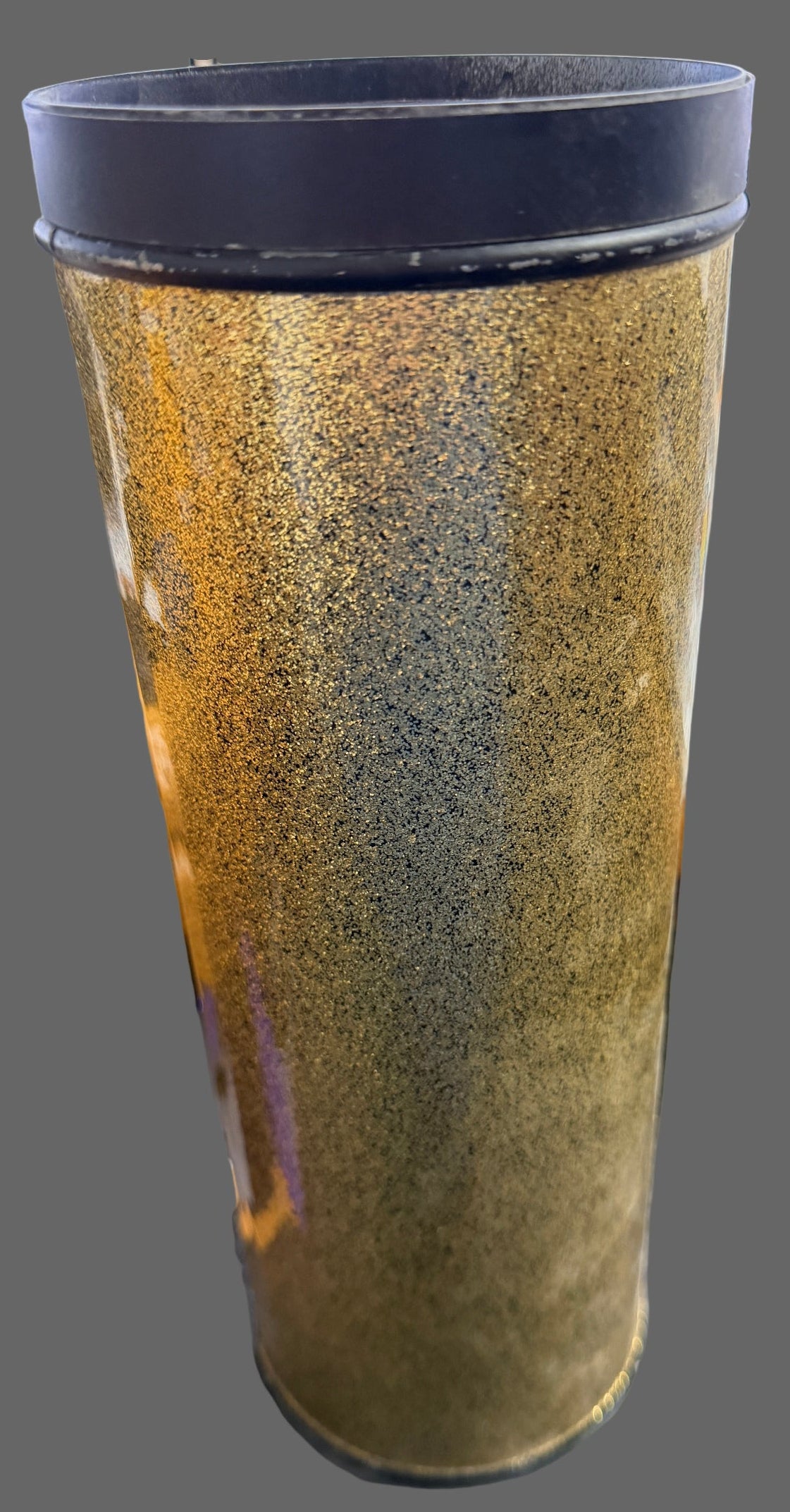 Brown cylindrical object with black ends on a blurred background