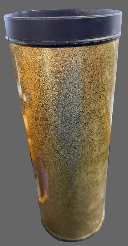 Brown cylindrical object with black ends on a blurred background