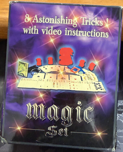 Magic set packaging with purple and black design on a dark surface