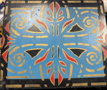 Decorative wooden panel with geometric pattern on a black background