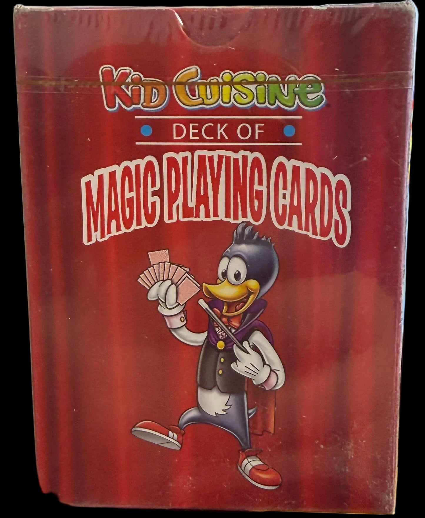 Red playing card box with cartoon character on a desk