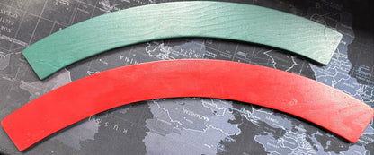 Two curved pieces of paper, one green and one red, on a world map background.
