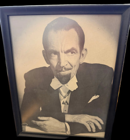 Vintage portrait of a man with a dark frame on a surface with a map.