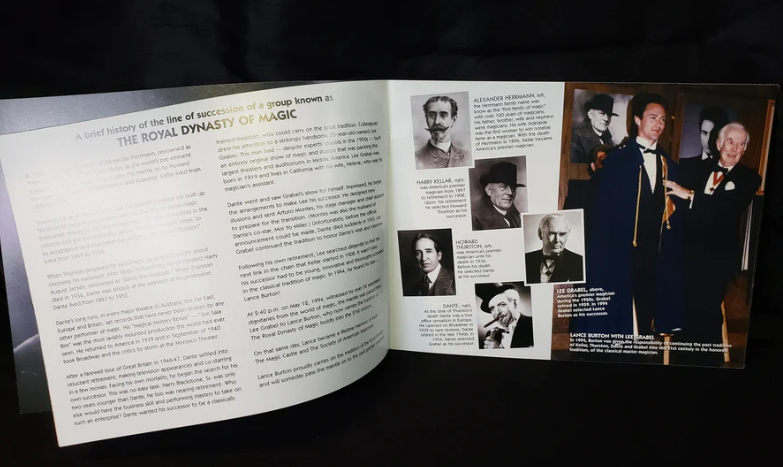 Open book with text and black and white photos on a dark background