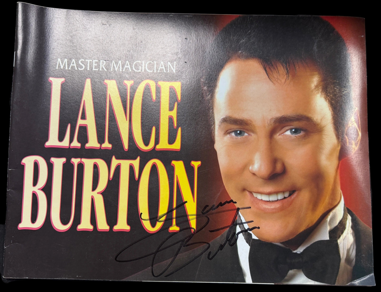 Promotional material for Master Magician Lance Burton with a portrait of the person on a dark background.