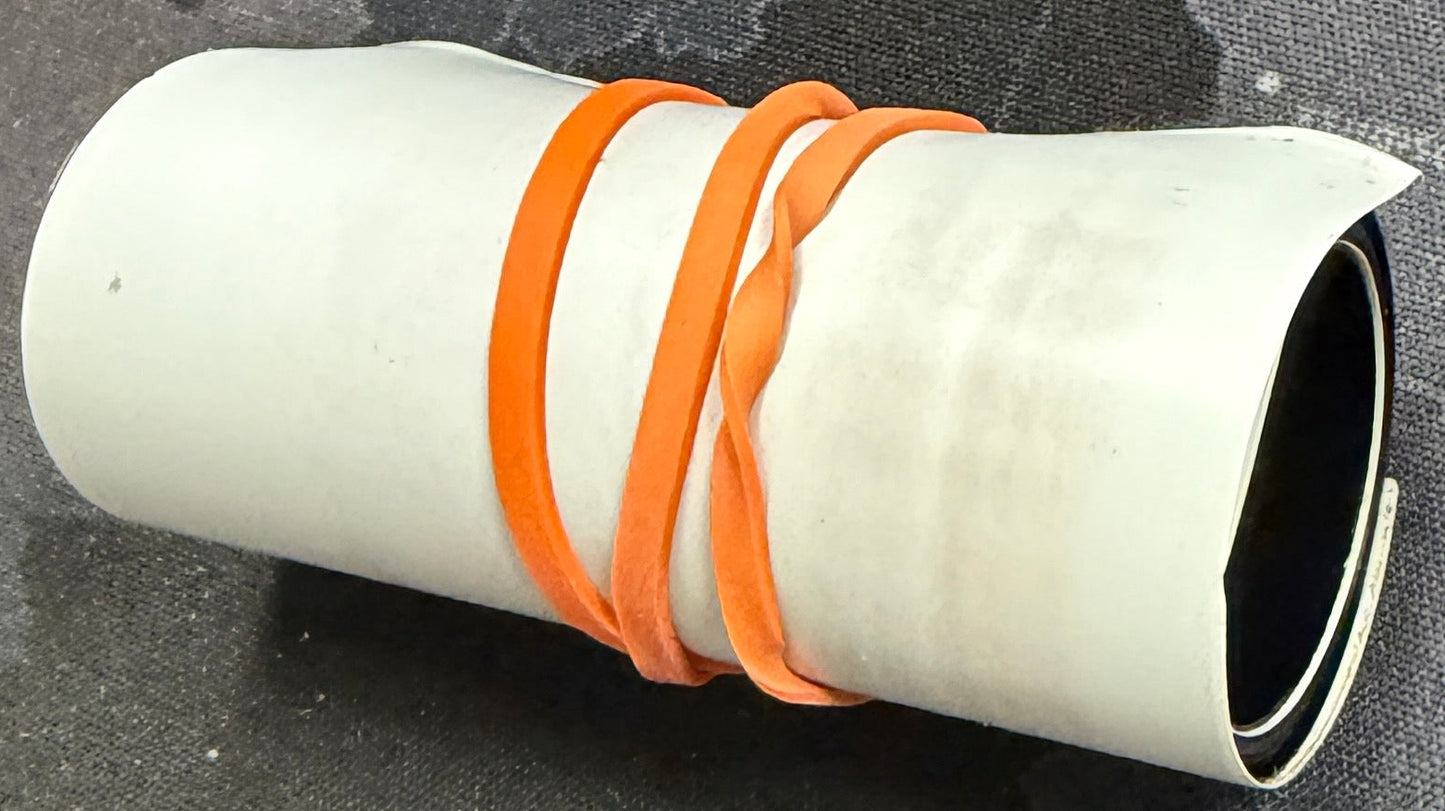 White cylindrical object with orange bands on a map background