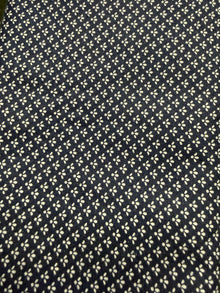 Navy blue fabric with small white floral pattern