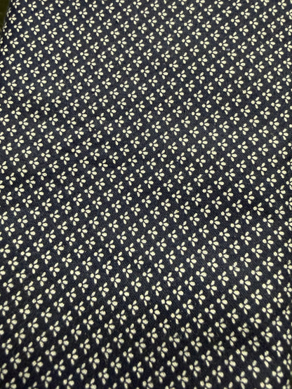 Navy blue fabric with small white floral pattern