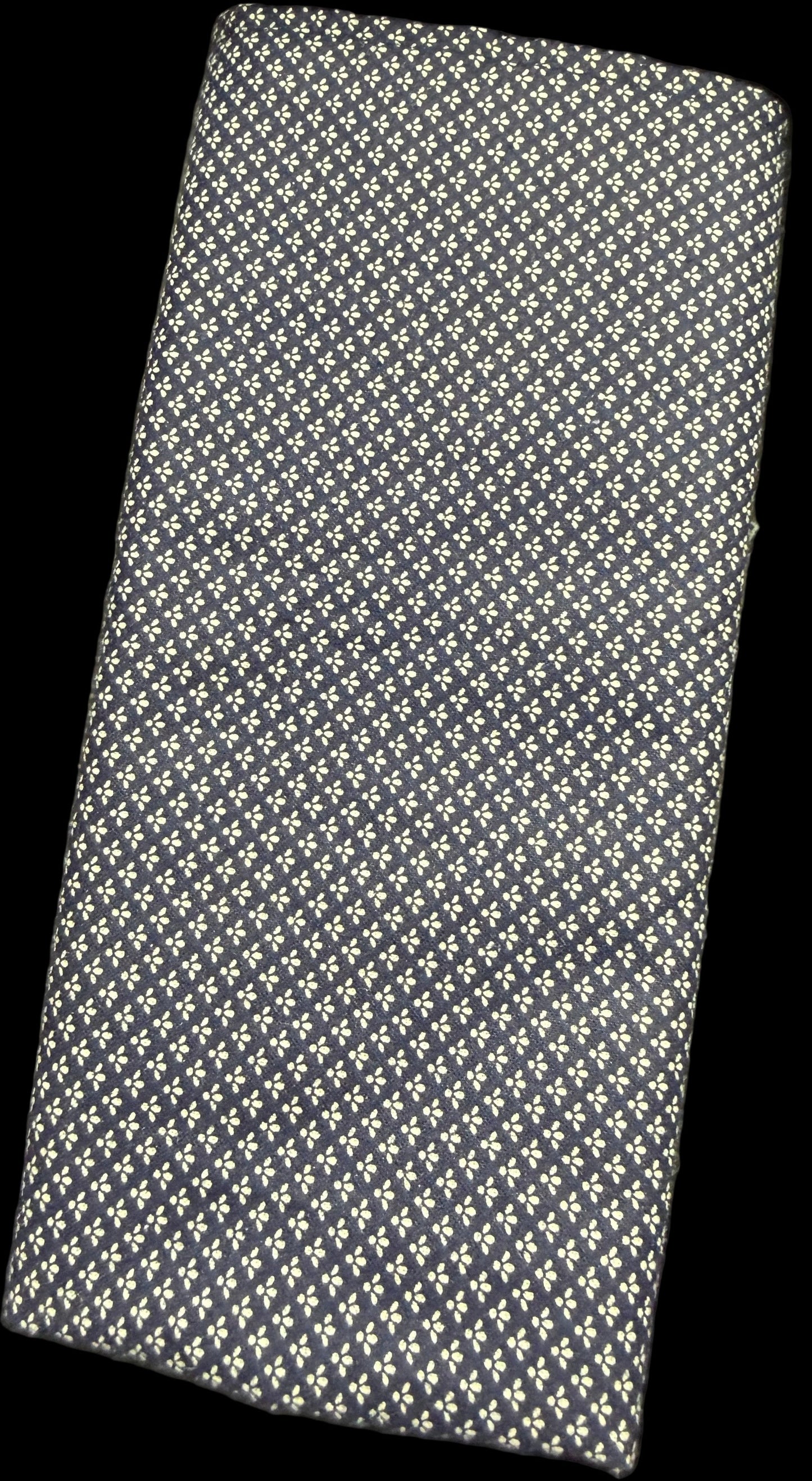 Textured black and white wallet on a surface with a blurred background