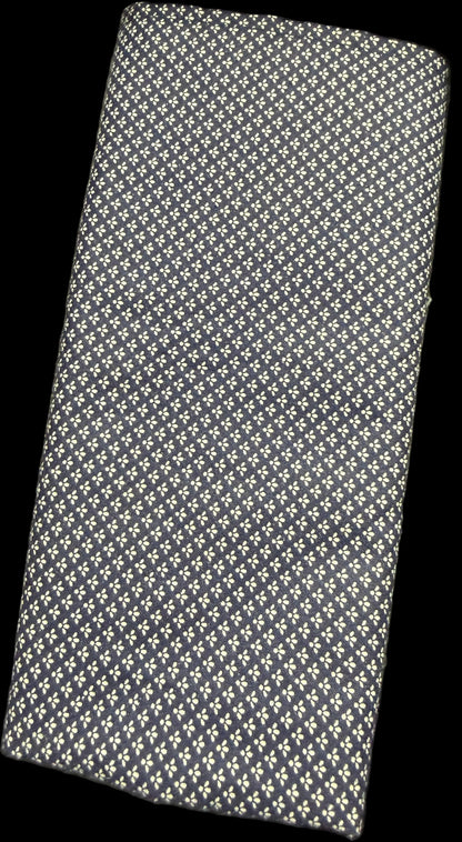 Textured black and white wallet on a surface with a blurred background