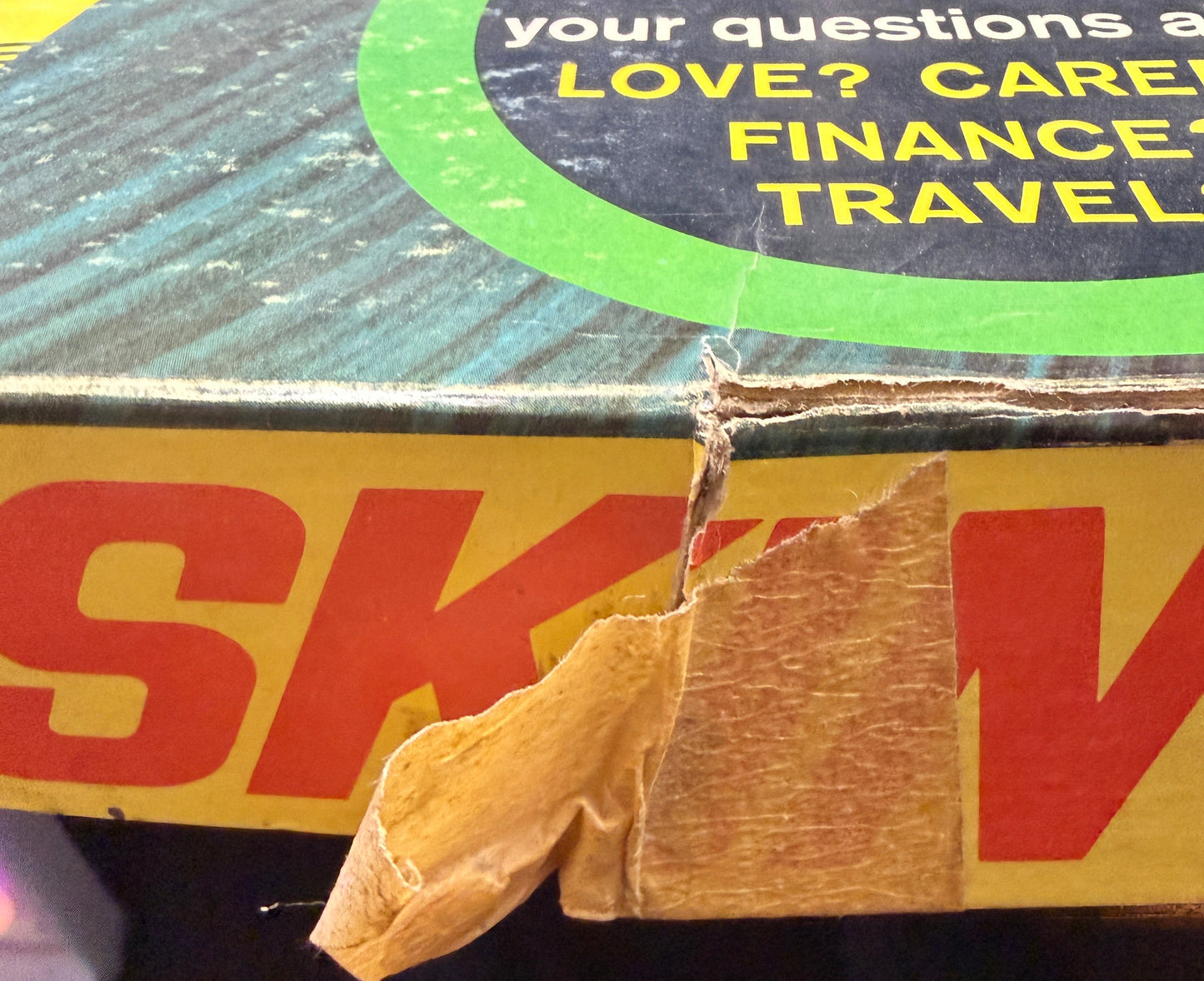 Close-up of a DHL shipping label on a package with text about love, care, finance, and travel.