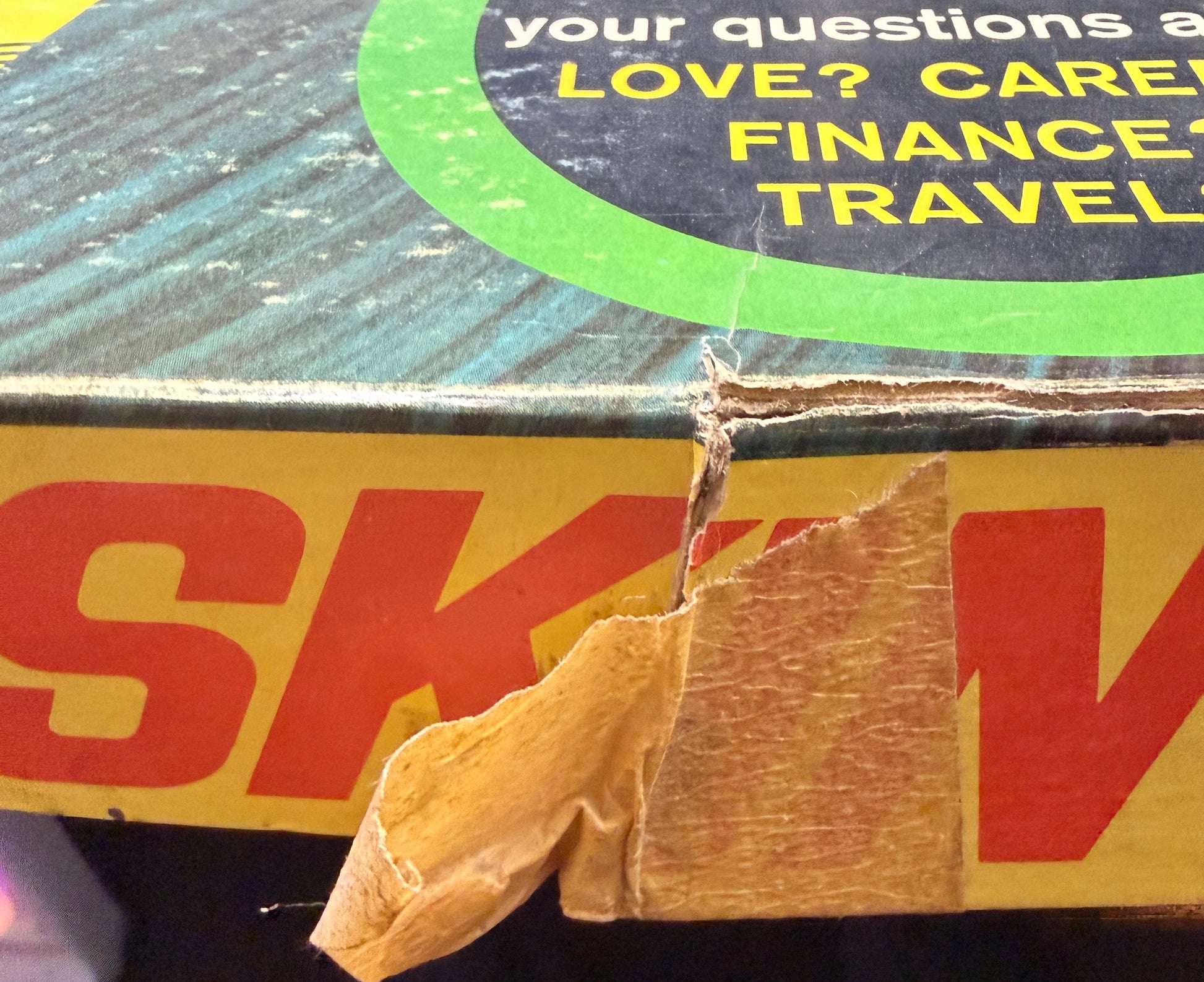 Close-up of a DHL shipping label on a package with text about love, care, finance, and travel.