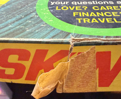 Close-up of a DHL shipping label on a package with text about love, care, finance, and travel.