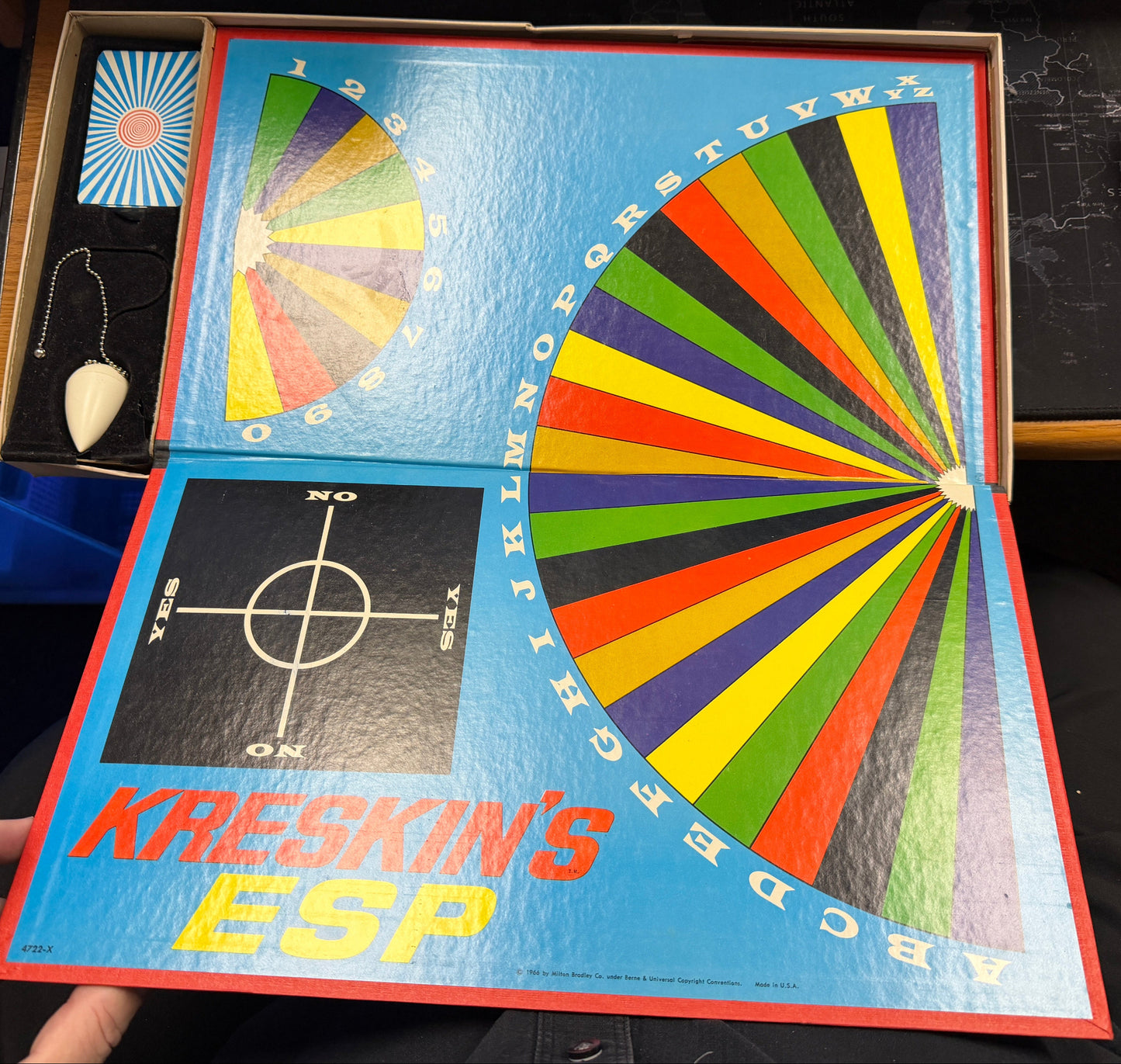 Kreskin's ESP game box with colorful wheel design held by a person.