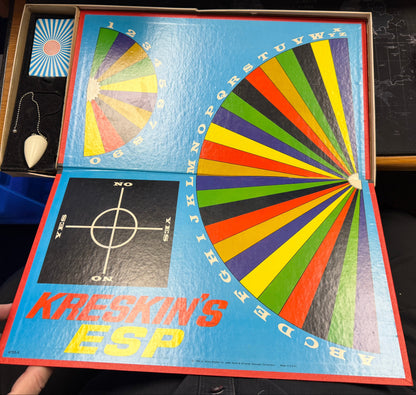 Kreskin's ESP game box with colorful wheel design held by a person.