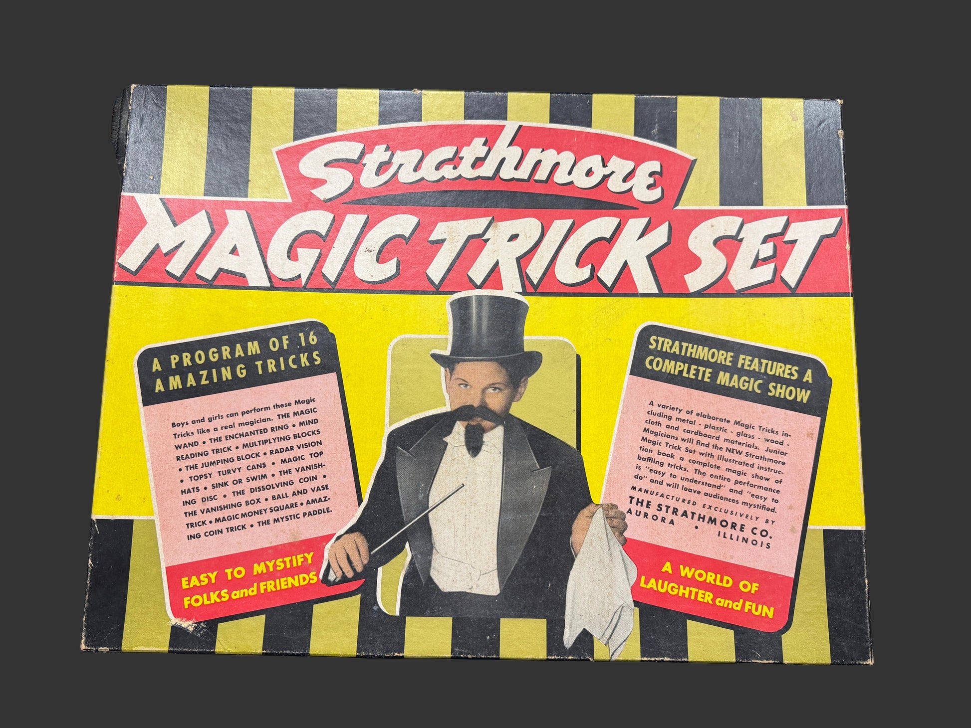 Strathmore Magic Trick Set packaging with a magician illustration on a yellow and black striped background.