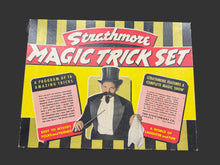 Strathmore Magic Trick Set packaging with a magician illustration on a yellow and black striped background.