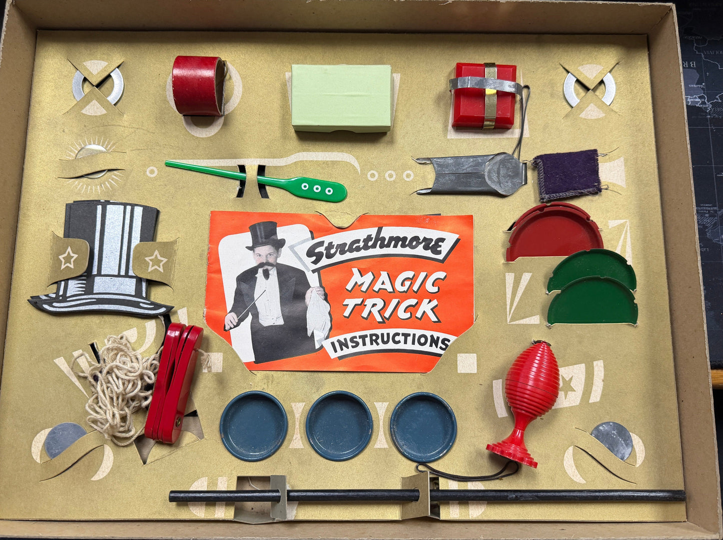 Strathmore magic trick kit with various components and instructions on a cardboard box.