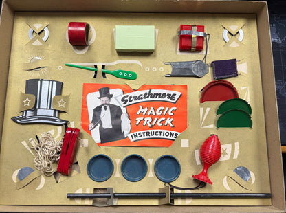 Strathmore magic trick kit with various components and instructions on a cardboard box.