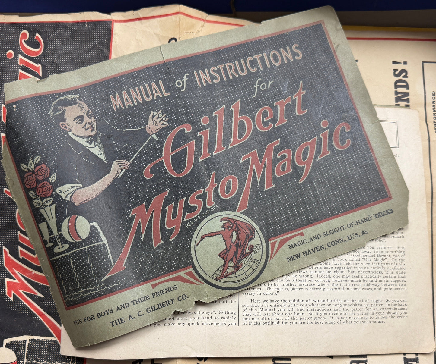 Vintage 'Manual of Instructions for Gilbert Mysto Magic' on top of a magazine with colorful illustrations.