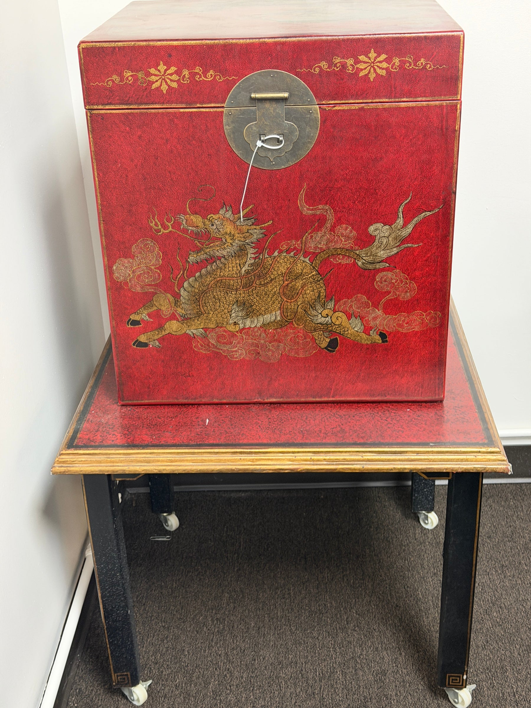 Decorative red book with gold dragon design on a white surface