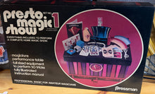 Presto Magic Show 1 box on a wooden shelf with various items around