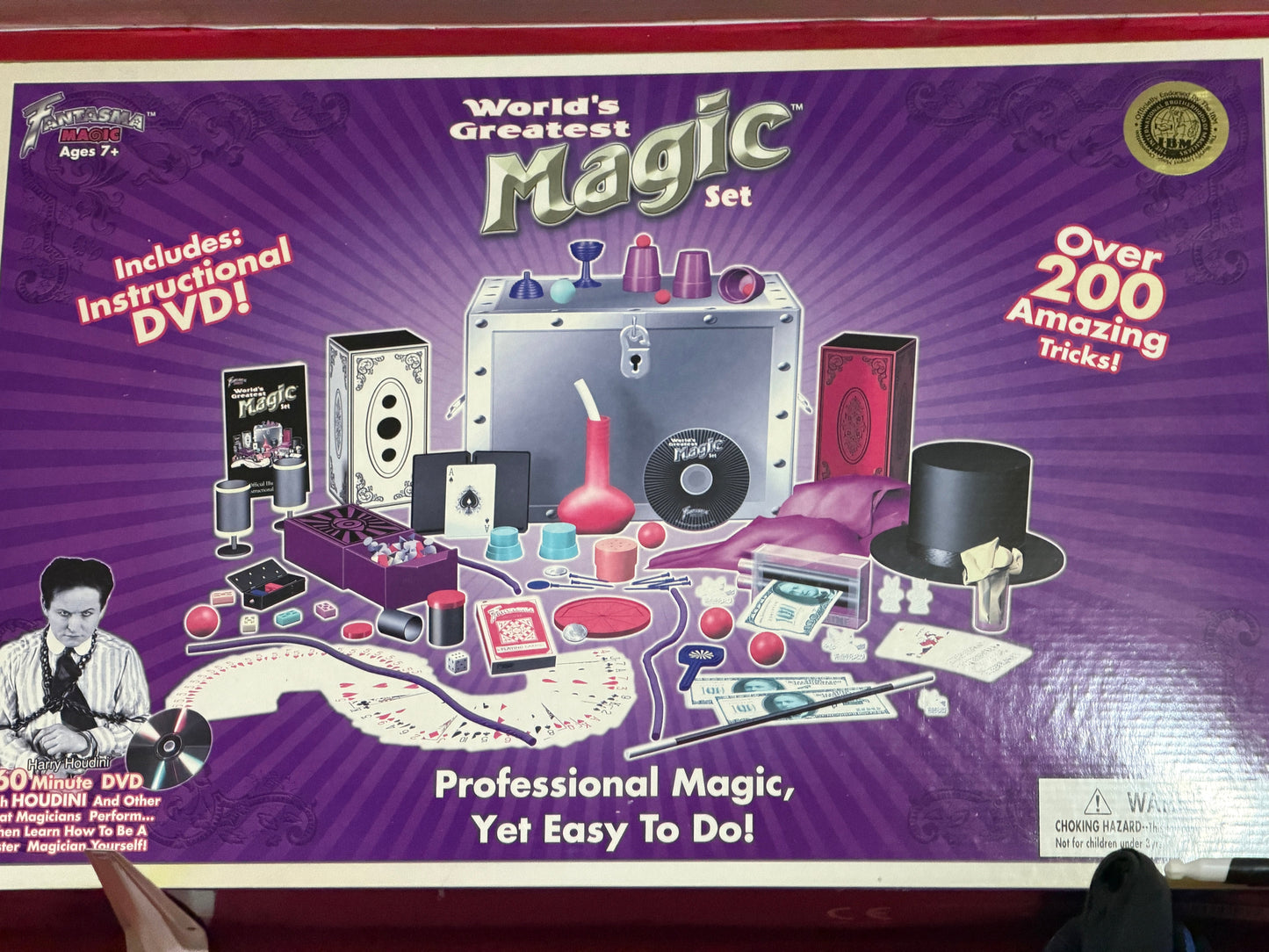 World's Greatest Magic Set packaging with various magic props and an instructional DVD on a purple background.
