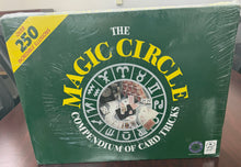 Green book titled 'The Magic Circle' on a wooden surface