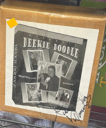 Shelf with board games and a box of Kleenex tissues.
