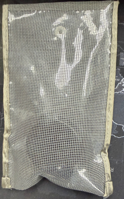 Mesh pouch on a dark surface with a map background