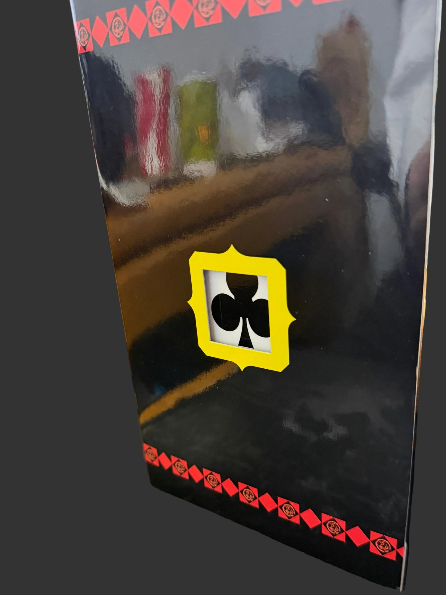 Black rectangular object with a yellow and black logo on a textured surface