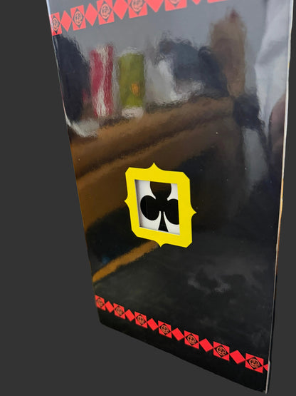 Black rectangular object with a yellow and black logo on a textured surface