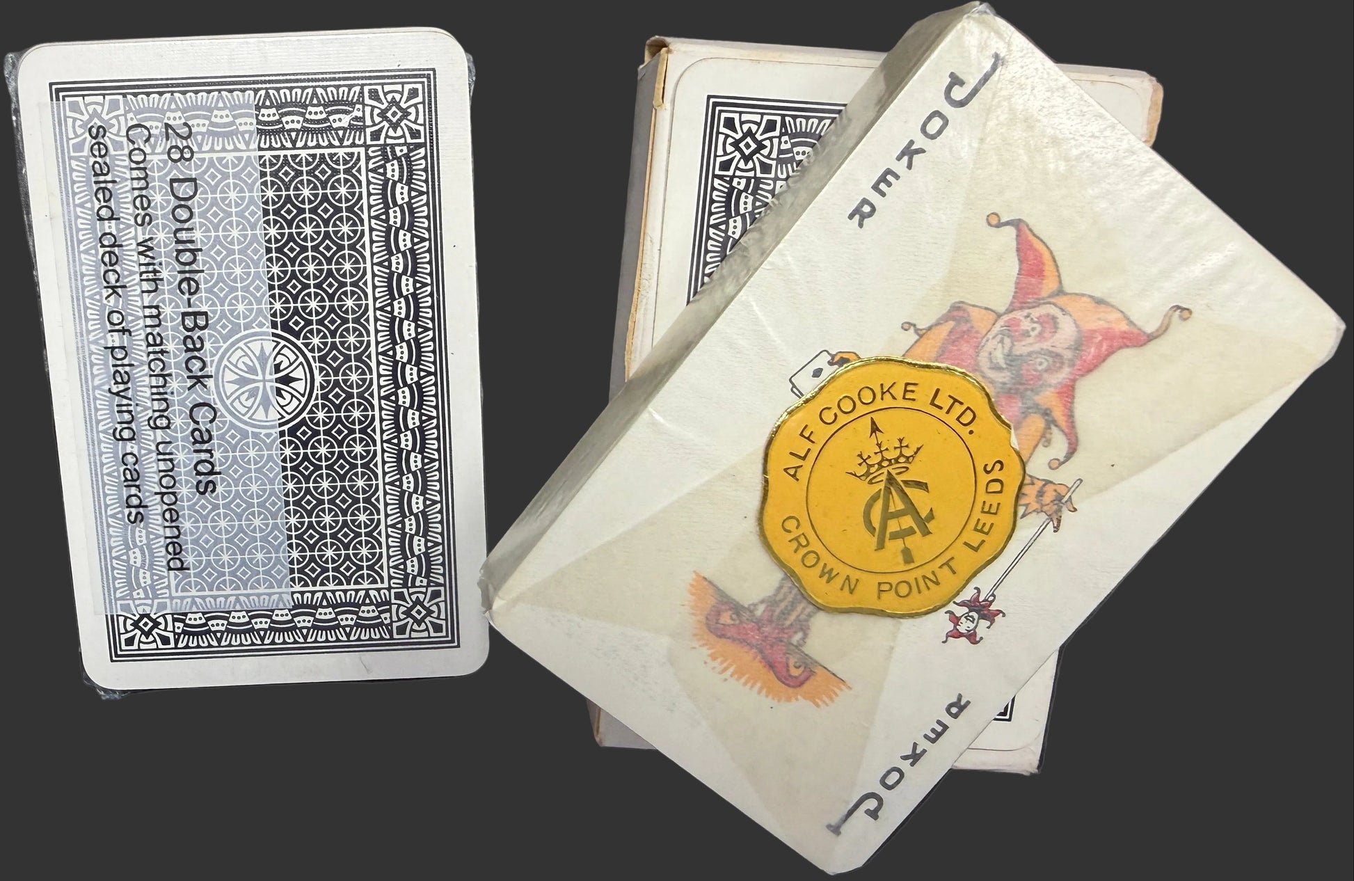 Playing cards with visible branding on a dark surface