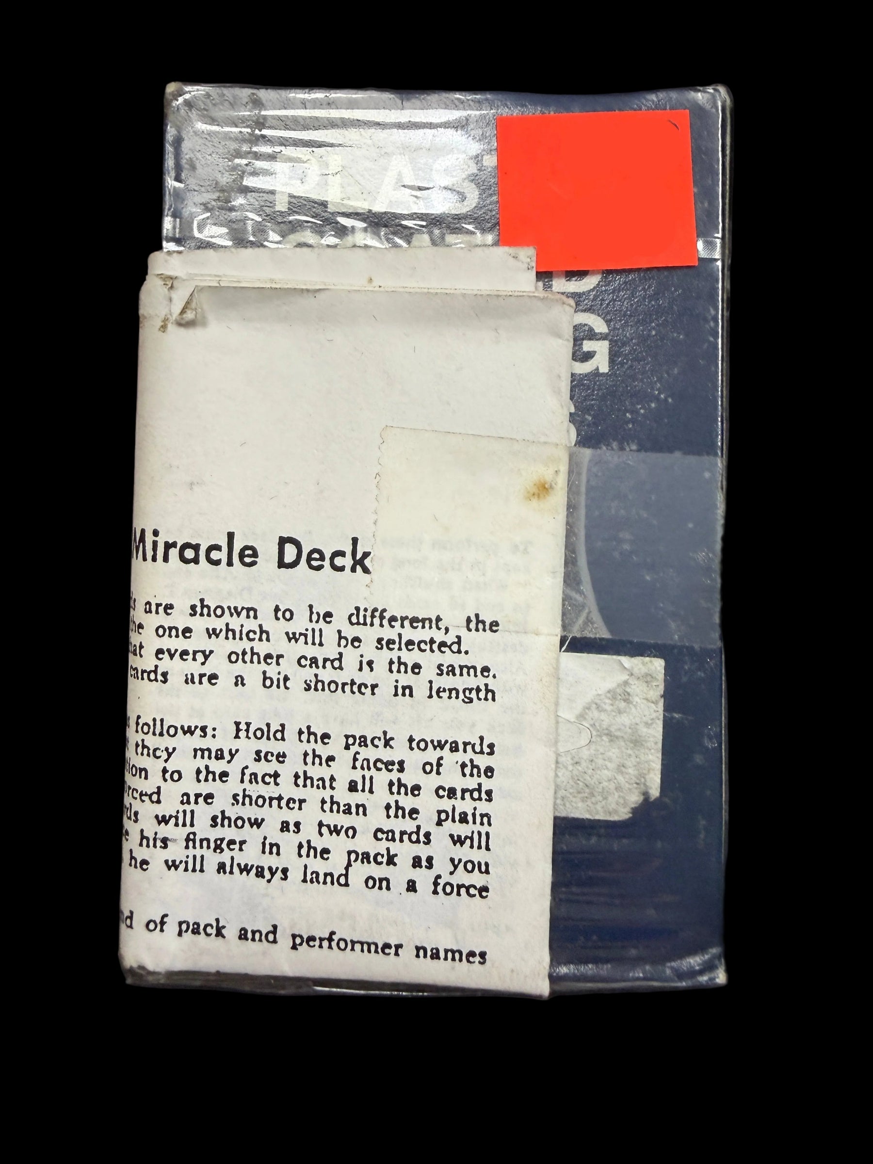 Card deck packaging with text and a price tag on a dark background