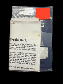 Card deck packaging with text and a price tag on a dark background