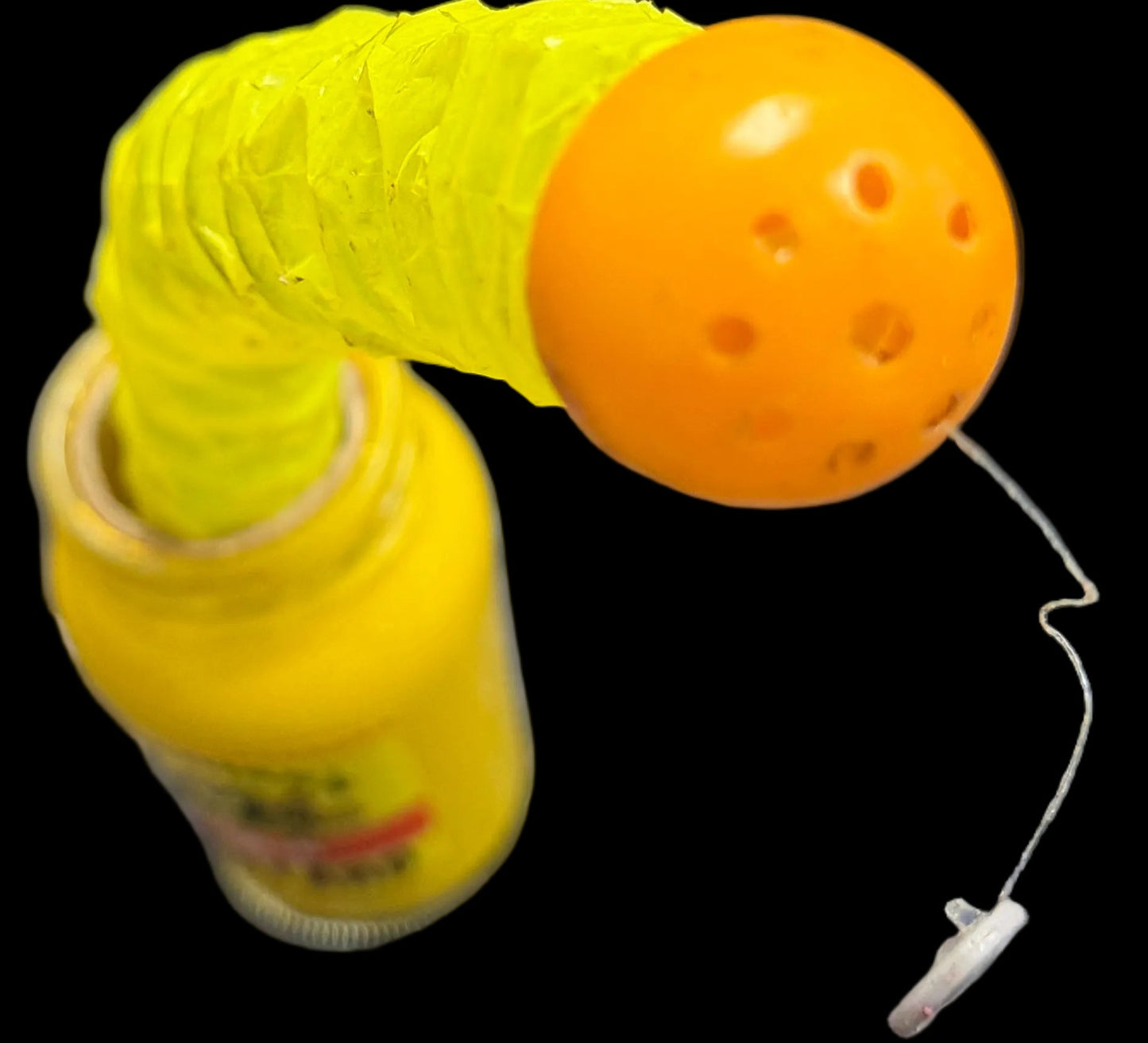 Yellow and orange object on a desk with keyboard and mouse