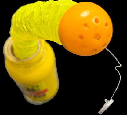 Yellow and orange object on a desk with keyboard and mouse