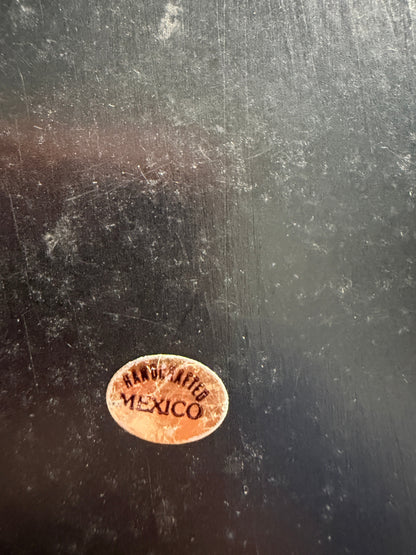 Small oval stamp on a dark textured surface