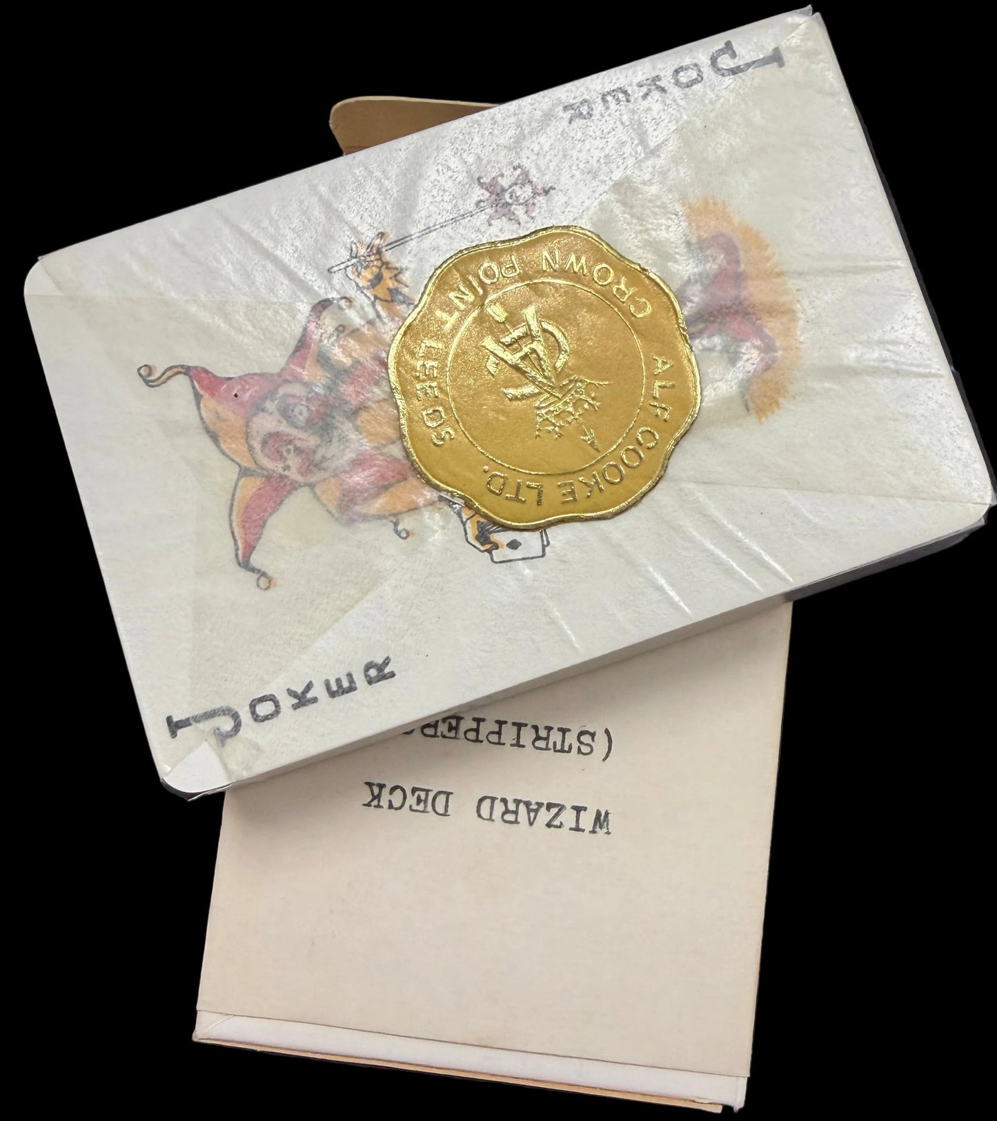 Two vintage-style cards with gold and white design on a dark surface