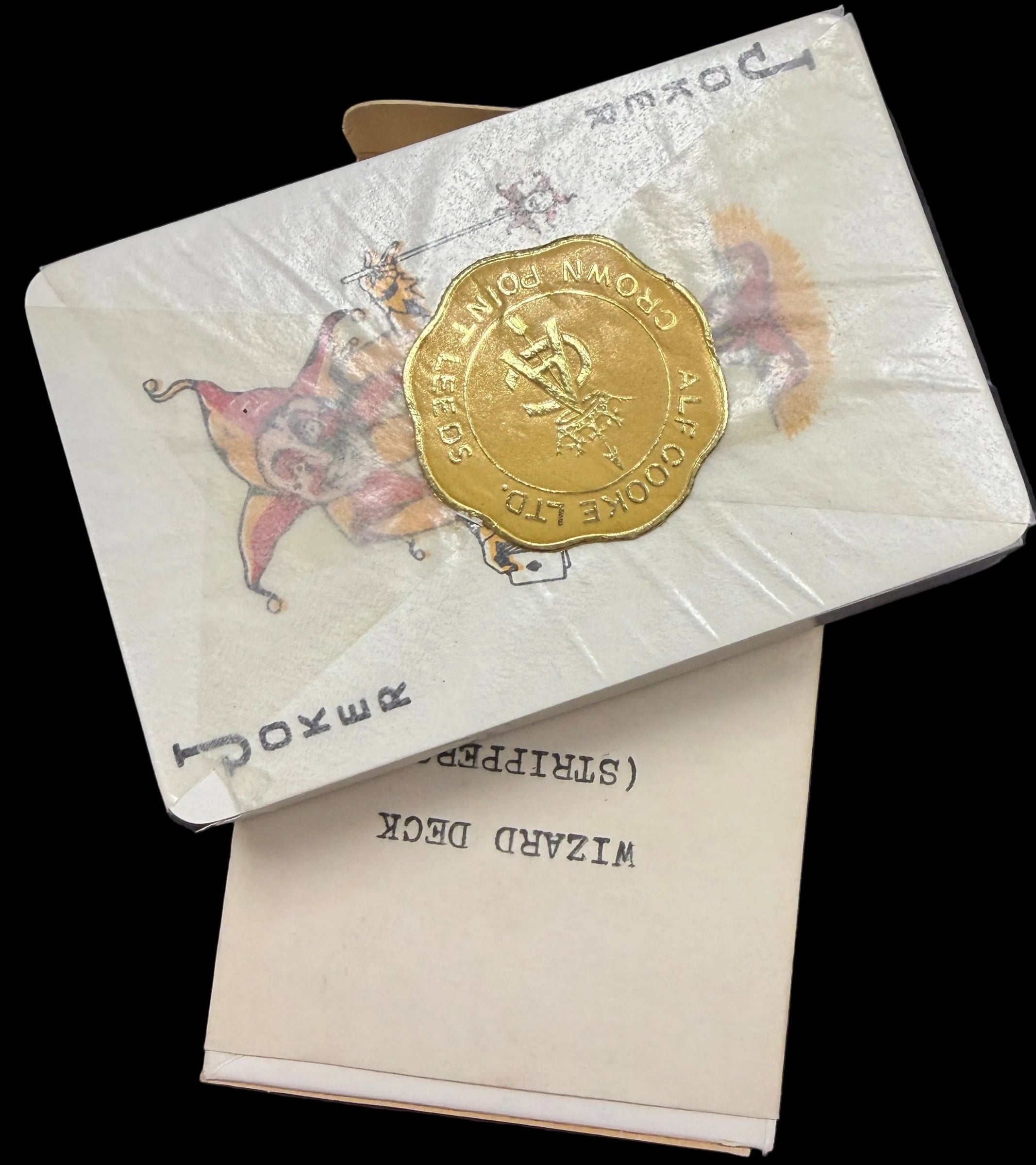 Two vintage-style cards with gold and white design on a dark surface