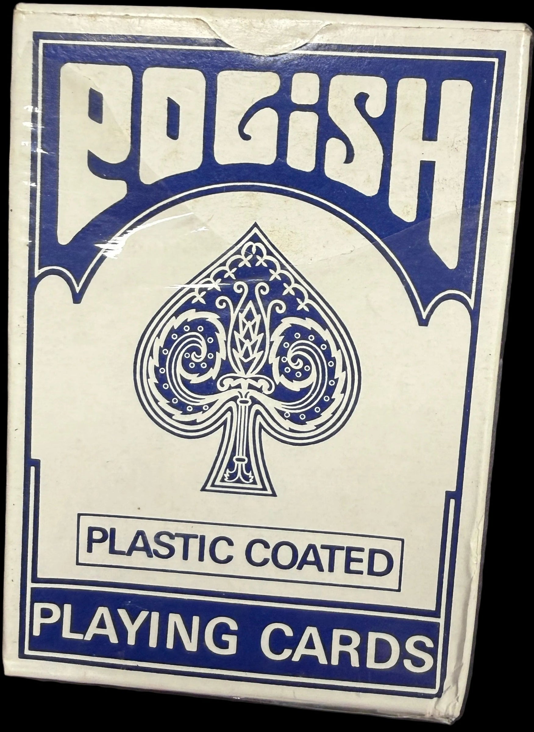 Pack of playing cards with blue and white design on a dark background