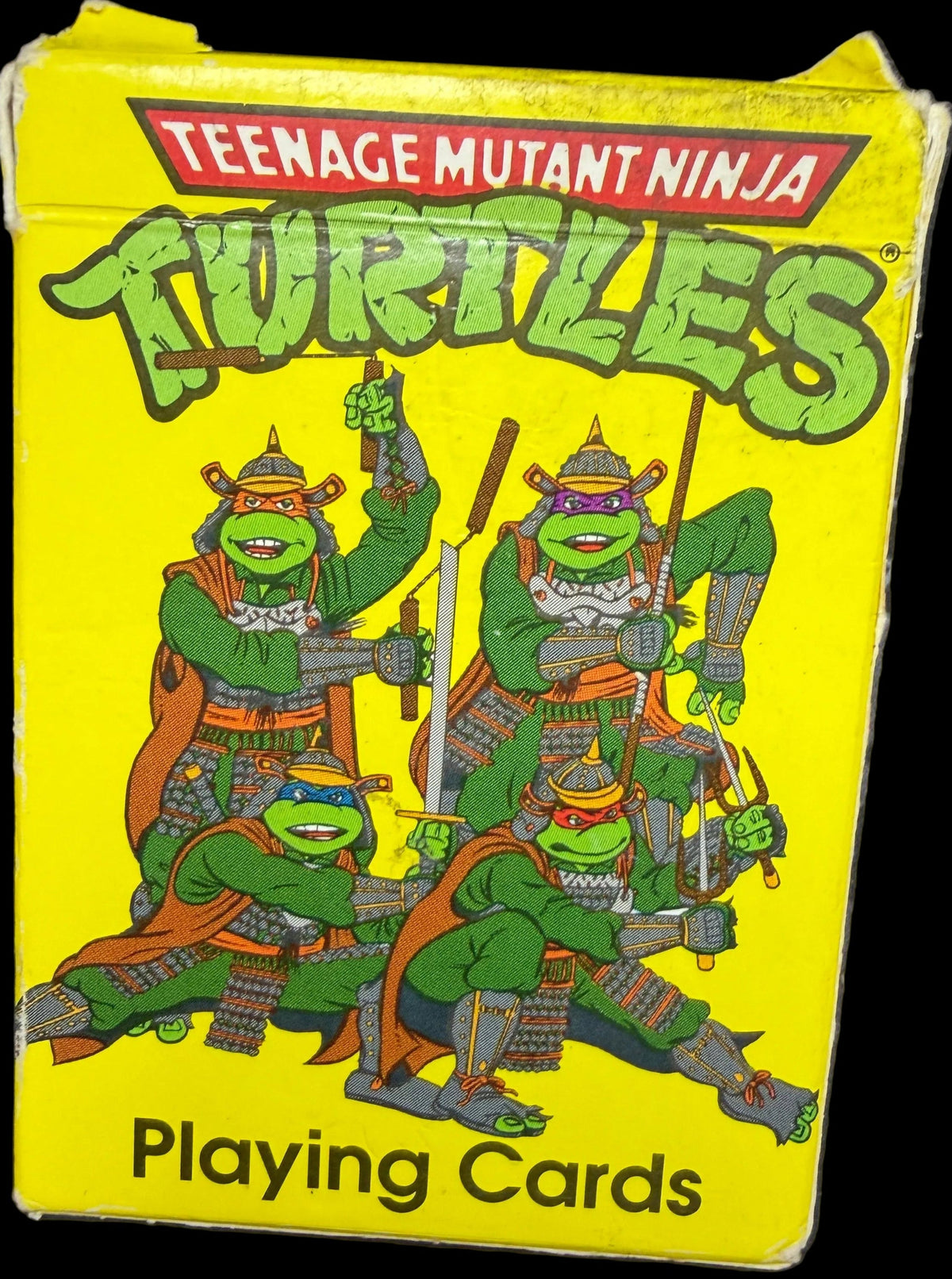 Pack of Teenage Mutant Ninja Turtles playing cards with yellow background and green turtles on it.