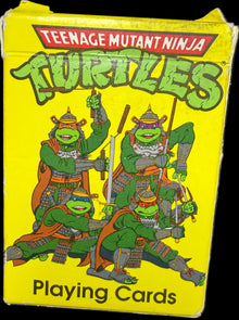 Pack of Teenage Mutant Ninja Turtles playing cards with yellow background and green turtles on it.