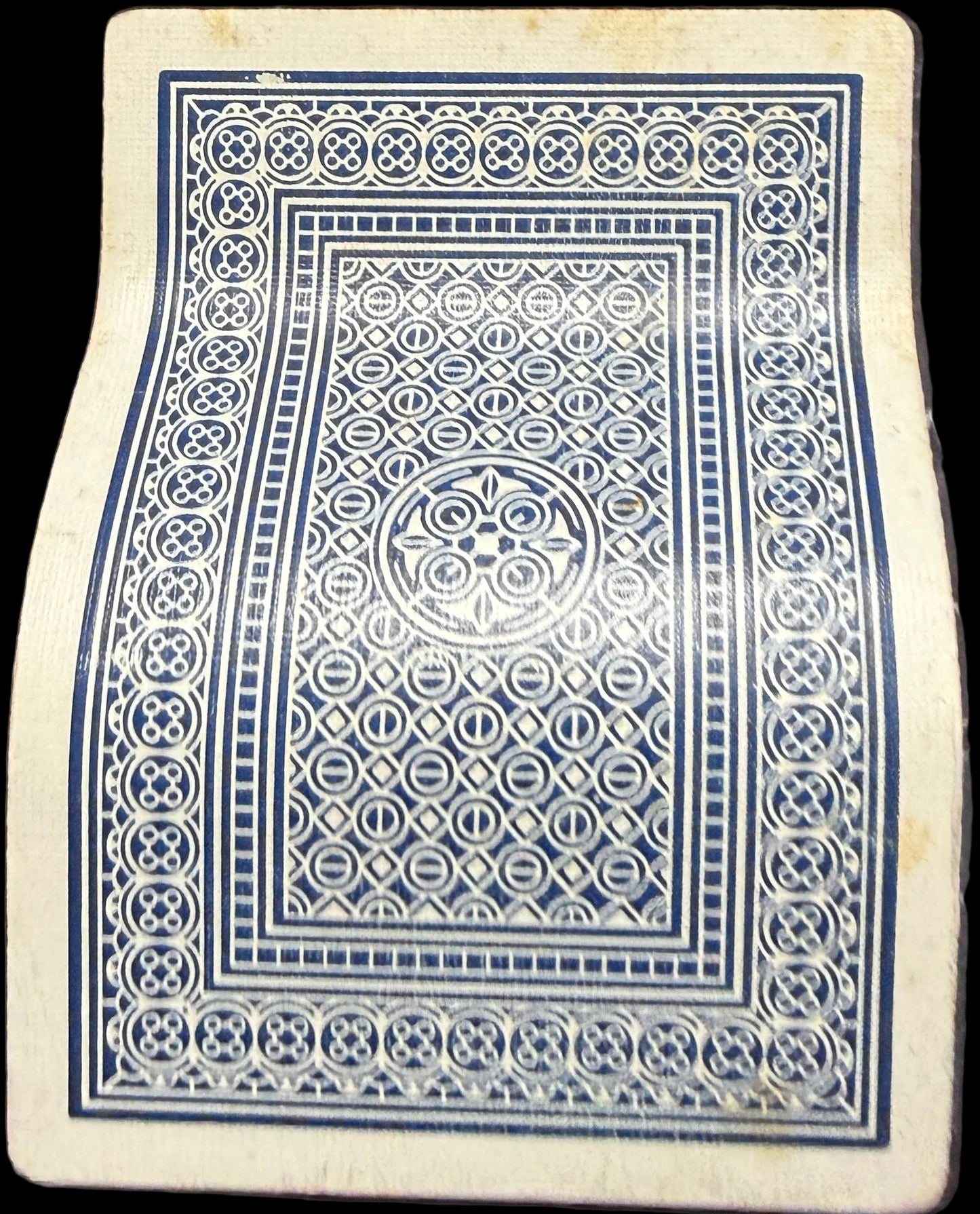 Playing card with a blue and white design on a map background