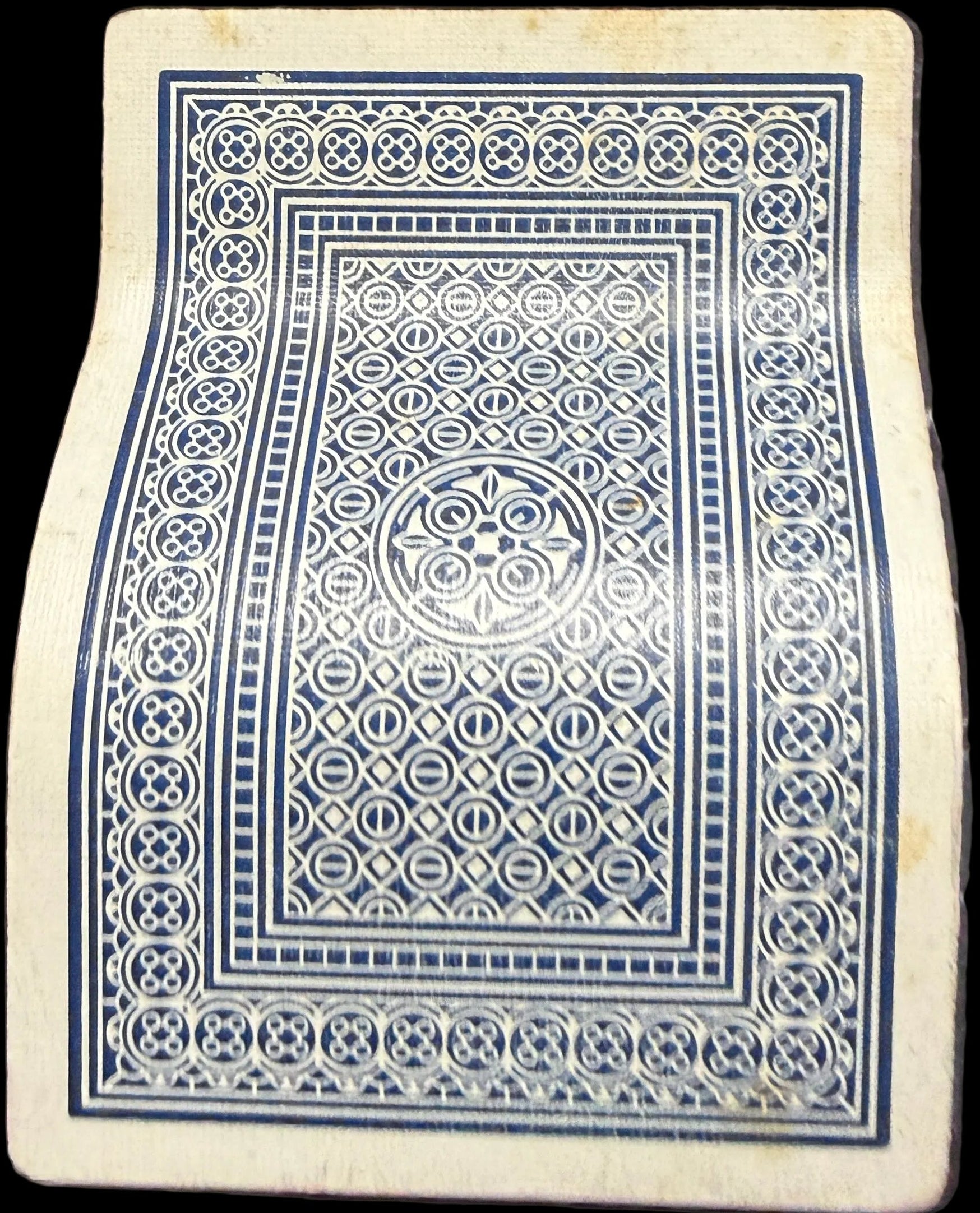 Playing card with a blue and white design on a map background