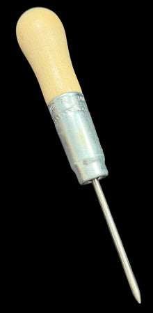 Sewing needle with wooden handle on a black background