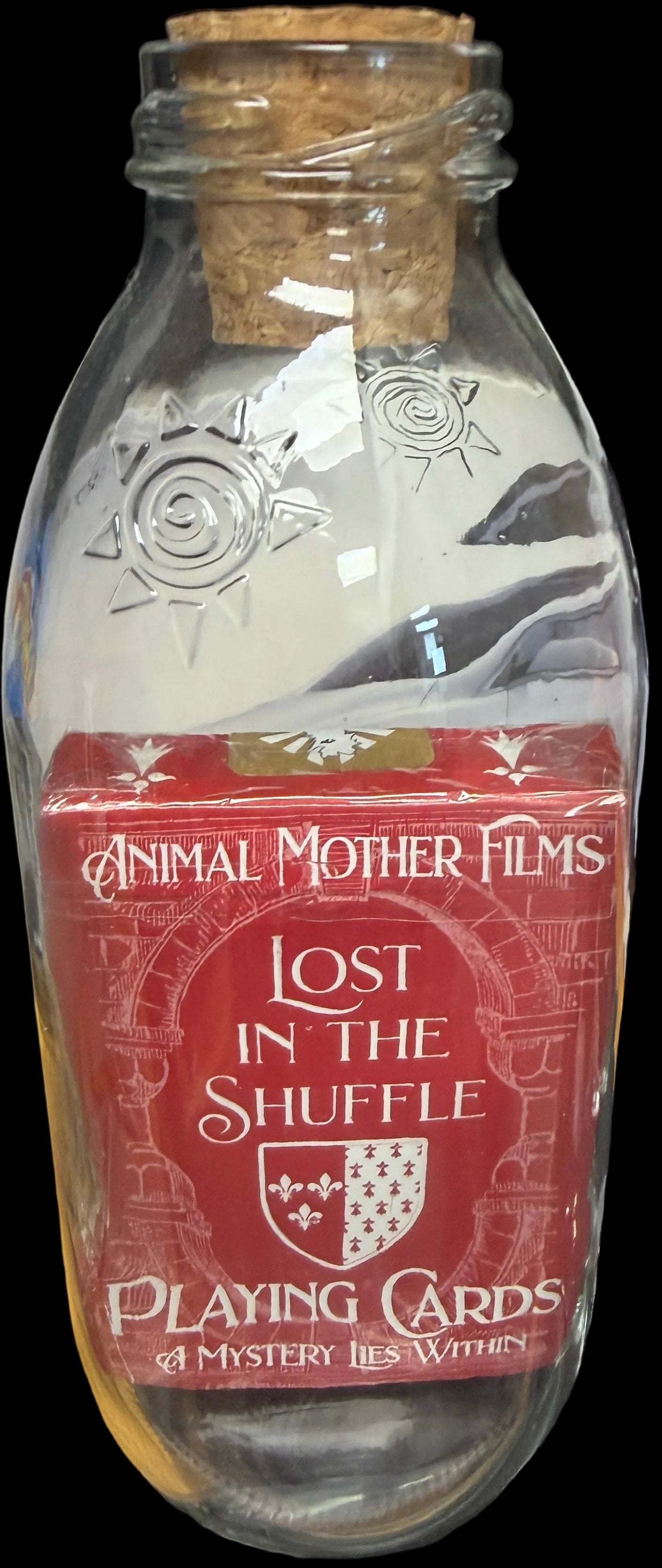 Bottle with a red label featuring 'Animal Mother Films' and 'Lost in the Shuffle Playing Cards'.