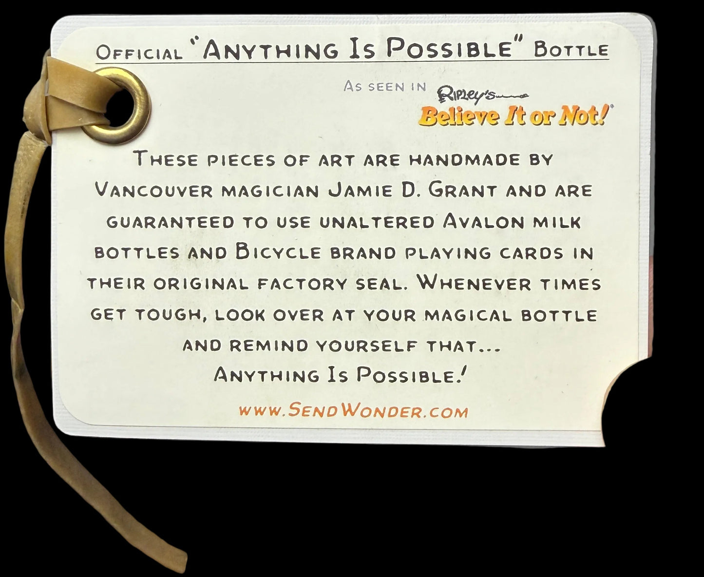 Label for 'Anything Is Possible' bottle with text and a strap on a black background